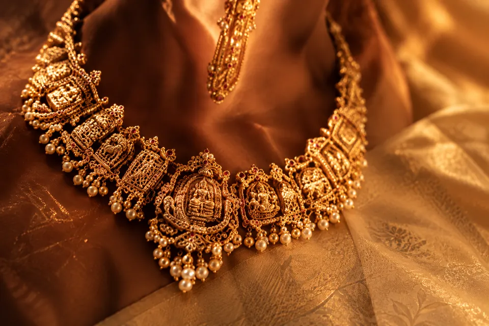 Antique gold temple necklace on silk